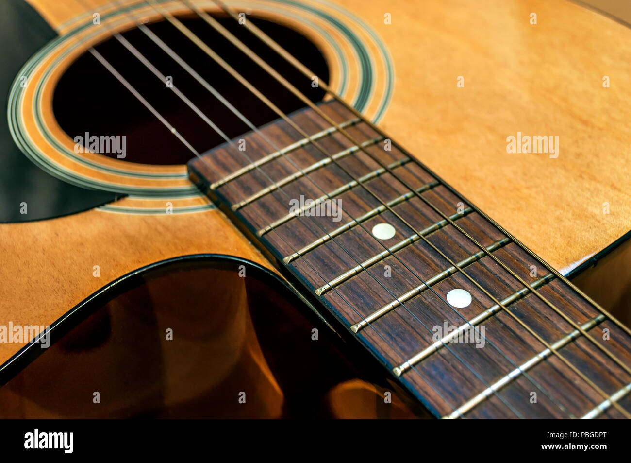 Large acoustic guitar with sound hole and pickguard Stock Photo