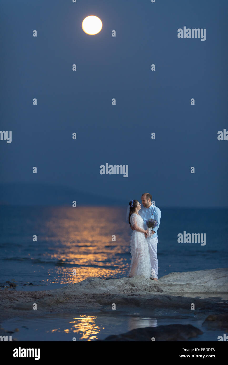 Bride and groom under the full moon, Bride and groom under the moon light, most romantic wedding photo Stock Photo