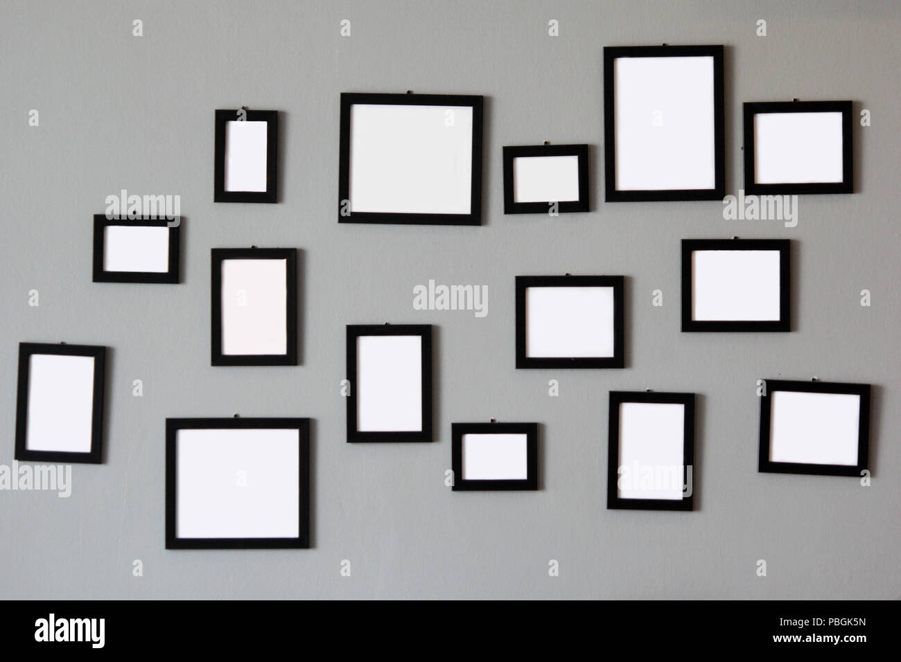 pile of empty wooden picture frames on gray wall Stock Photo - Alamy