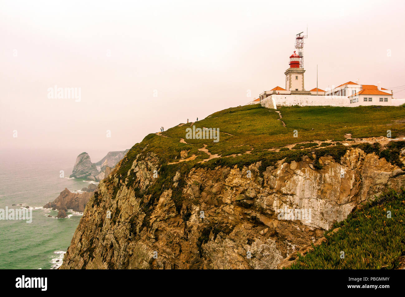 The lighthouse of Roca's Cape and the cliffs on the Atlantic ocean in Portugal Stock Photo