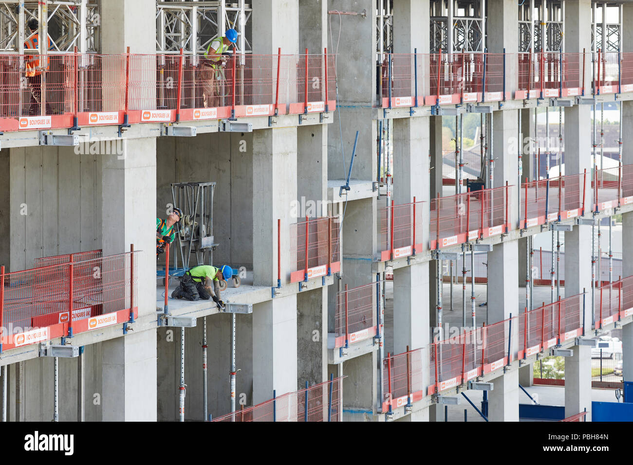 Construction worker adding safety rails to a construction site in salford, MediaCityUK greater manchester Stock Photo