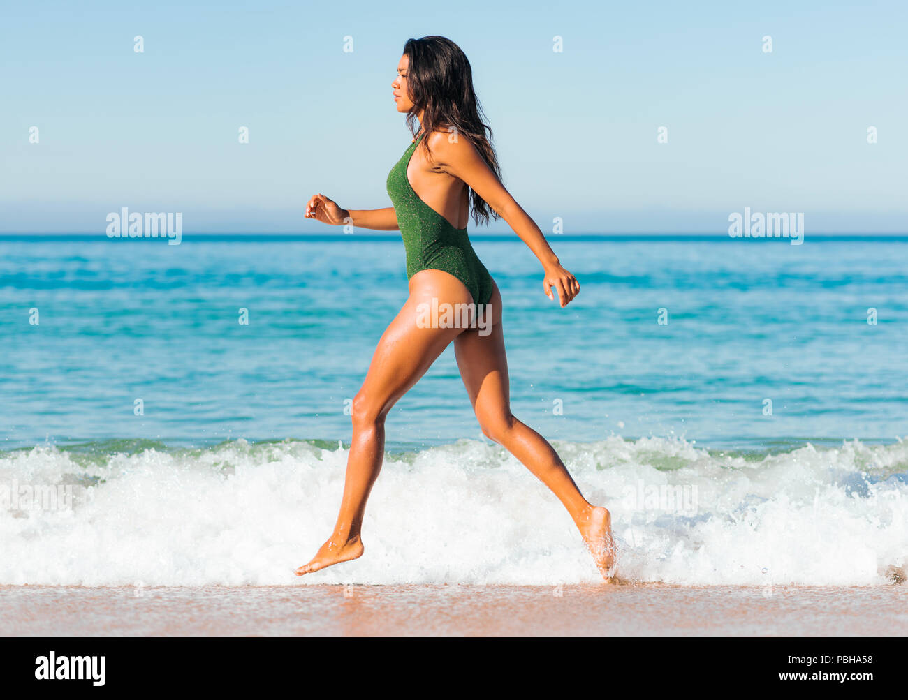 Woman exercising at the beach. Tarifa, Costa de la Luz, Cadiz, Andalusia, Spain. Stock Photo