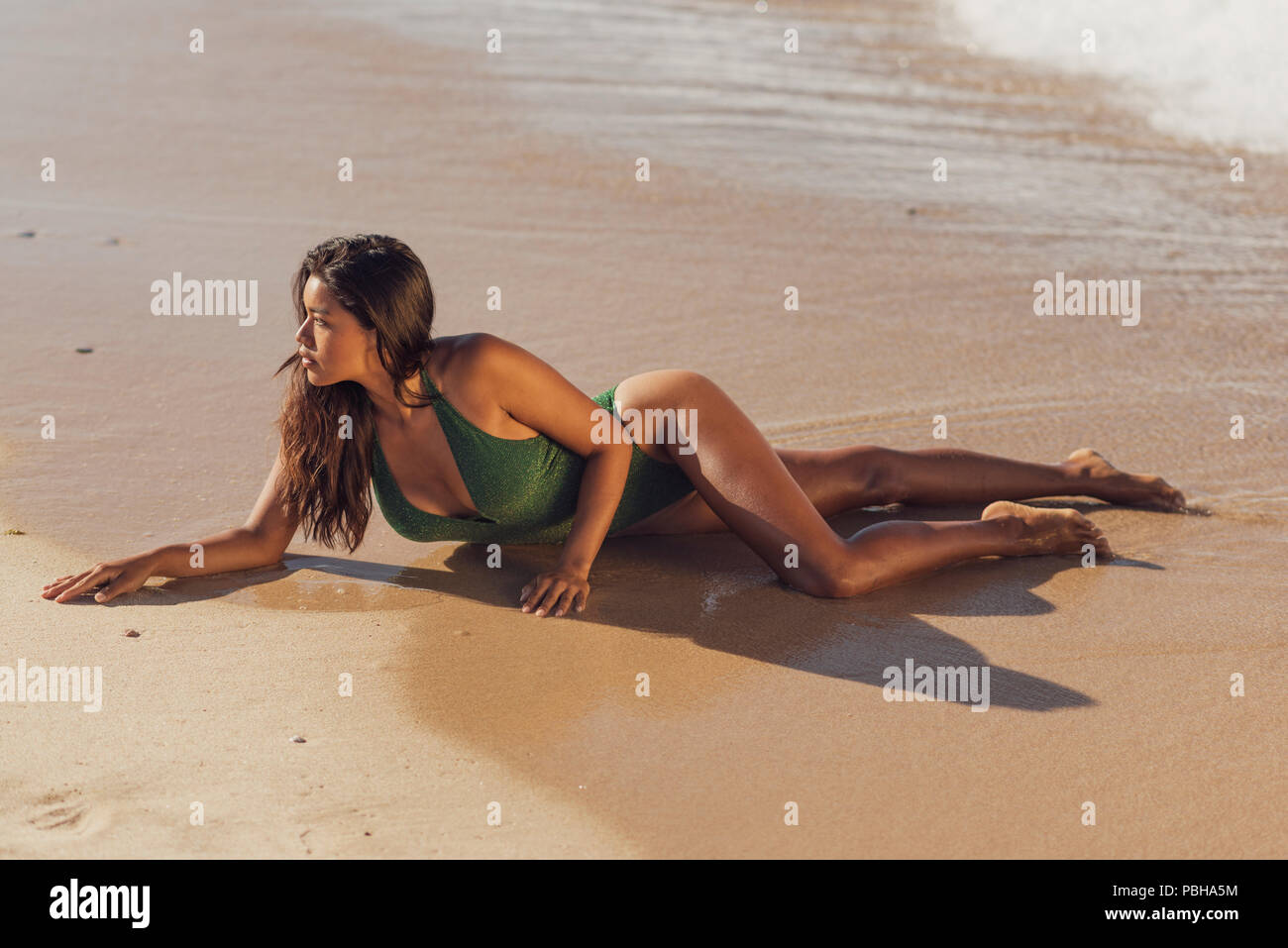 Exotic woman in a swimsuit. Tarifa, Costa de la Luz, Cadiz, Andalusia, Spain. Stock Photo