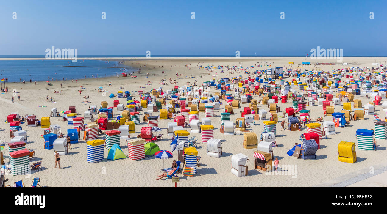Panorama of colorful traditional beach chairs at the coast of Borkum, Germany Stock Photo