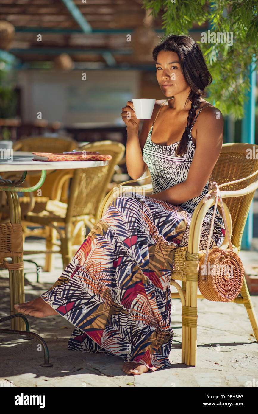 Woman drinking a coffee. Tarifa, Costa de la Luz, Cadiz, Andalusia, Spain. Stock Photo