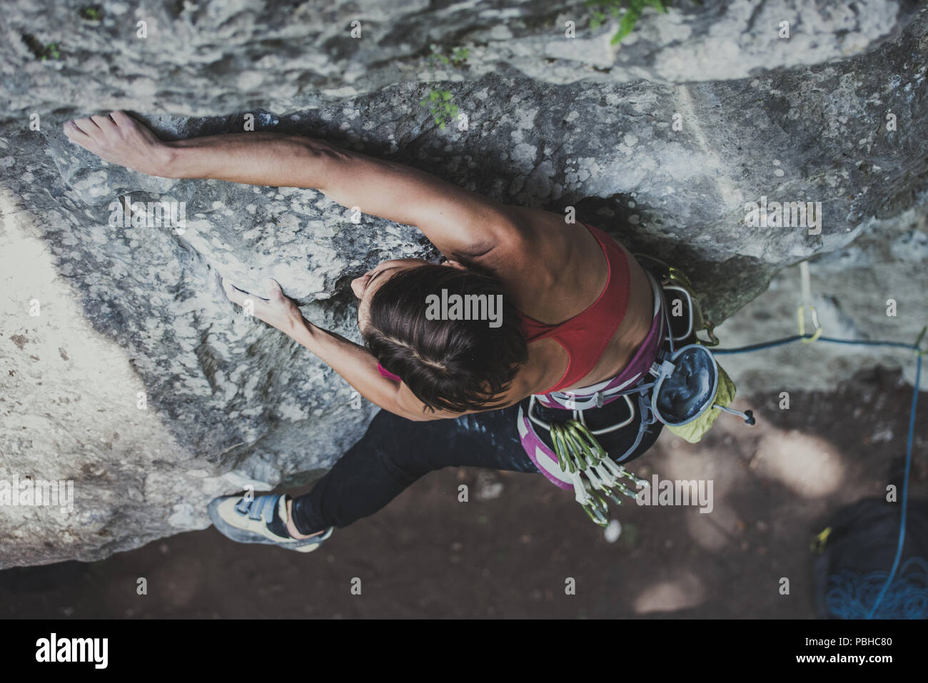Women climber on a rock. Going up with a rope. Stock Photo