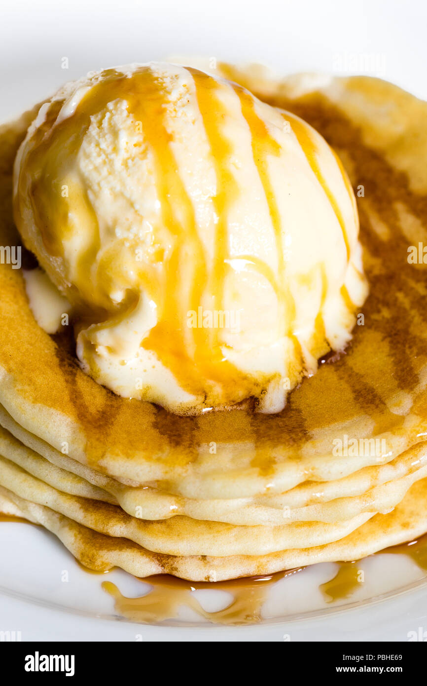 Stack of pancakes with ice cream and syrup Stock Photo