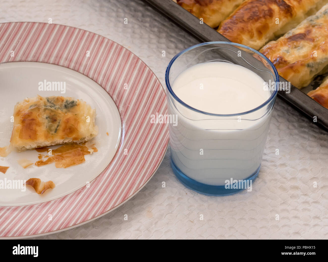 Eating spinach and cheese pie with yoghurt top view Stock Photo Alamy