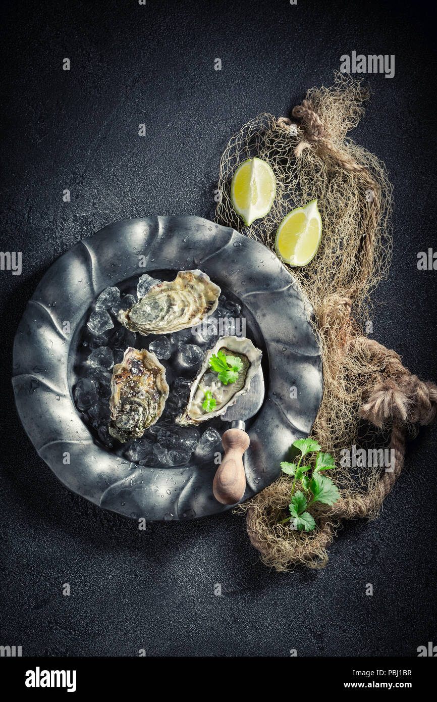 Delicious and fresh oysters with lemons and coriander Stock Photo Alamy
