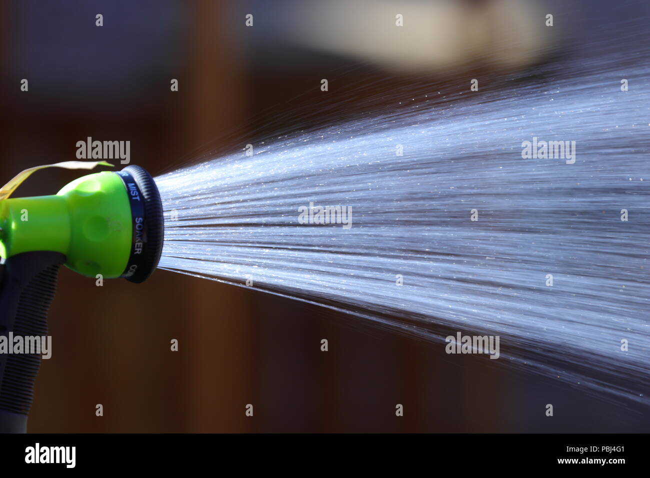 A shower of water from a hosepipe before the proposed hosepipe ban comes into effect. Stock Photo