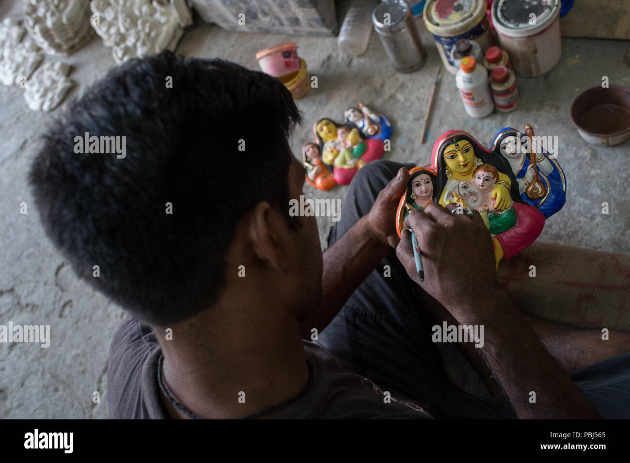 Artist at work. Mud religious statues of Kumortuli, the potters