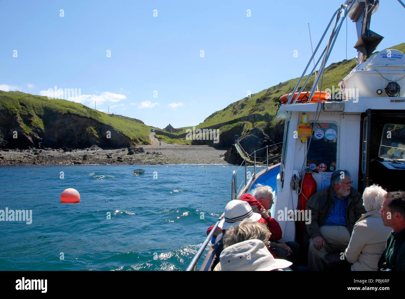 Passengers on small, sea going boat trip, St Brides Bay, Wales Stock Photo