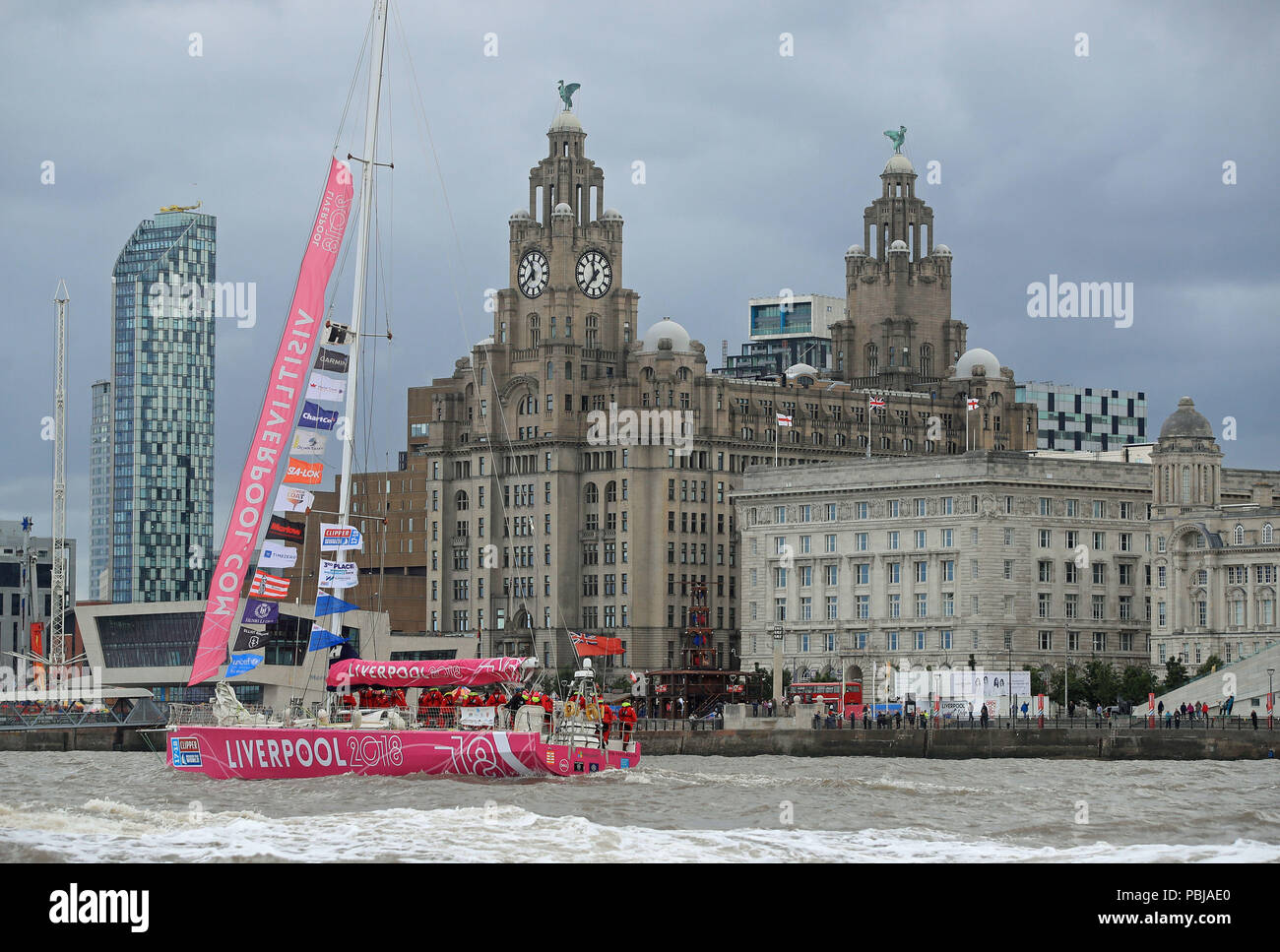 The Liverpool 2018 team arrives at the finish line after a "sprint finish" to conclude the Clipper 2017-2018 Round the World Yacht Race outside the Royal Albert Dock in Liverpool. Stock Photo