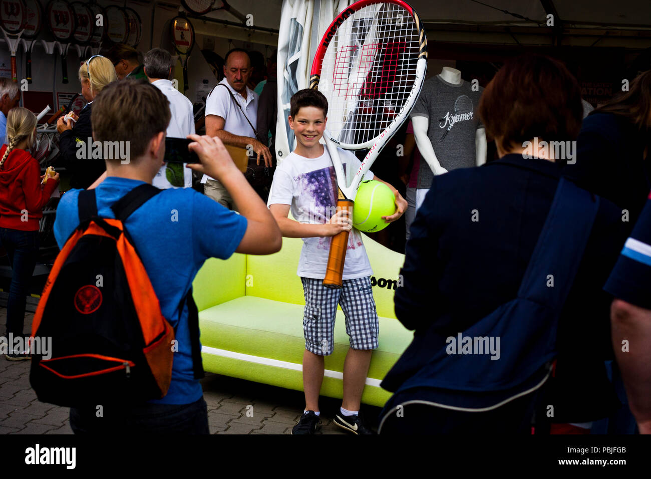 A young fan poses for a photograph with an oversized tennis racket and ball  at the Gerry Weber Stadion in Halle (Westfalen), Germany Stock Photo - Alamy
