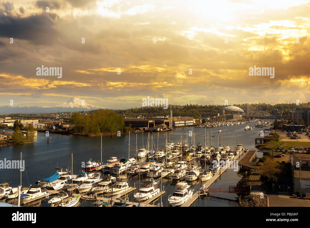 Boat Dock along Thea Foss Waterway in Tacoma Washington with Mount Rainier during golden sunset Stock Photo
