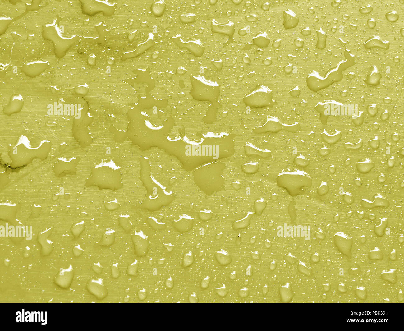 water drops on limelight colored metallic surface Stock Photo