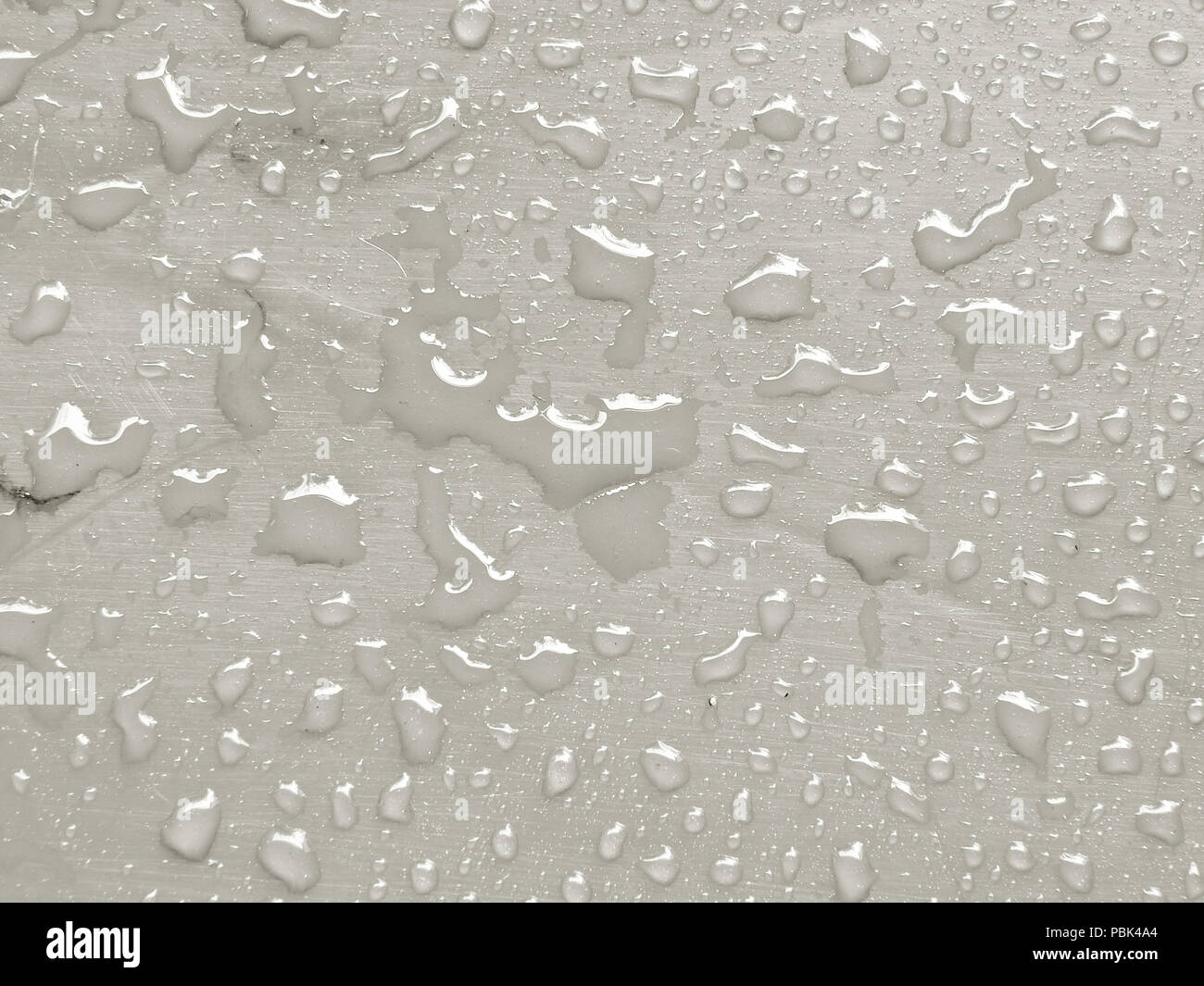 water drops on Tofu colored metallic surface Stock Photo