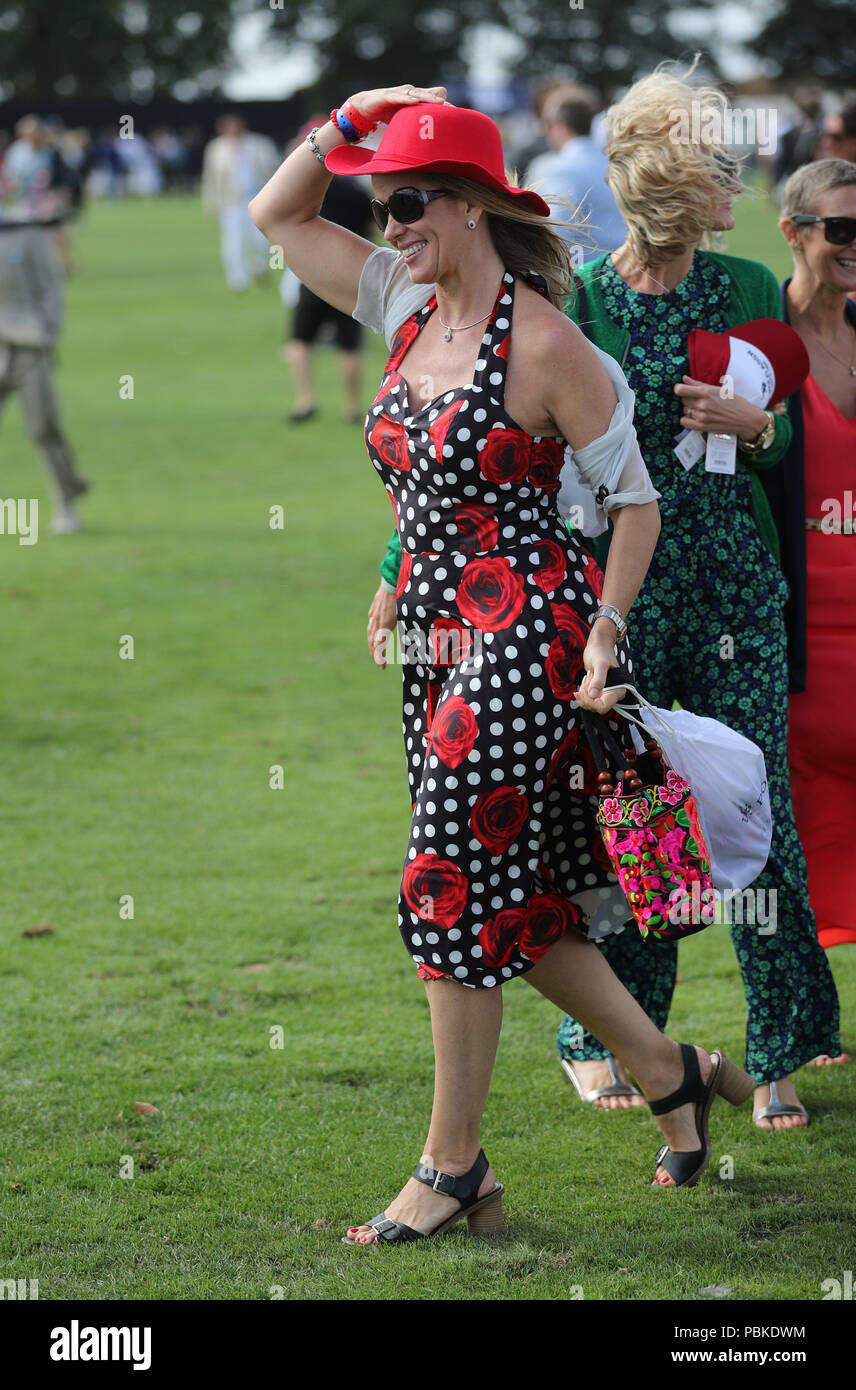 A woman holds her hat in the wind during the International Day at the Royal  County of Berkshire Polo Club in Winkfield, Windsor Stock Photo - Alamy