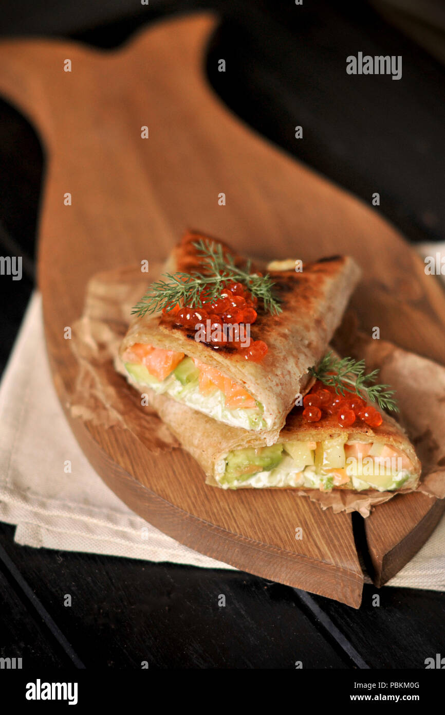 roll of bread with fish and caviar, delicious seafood. Asian cuisine. Copy space Stock Photo
