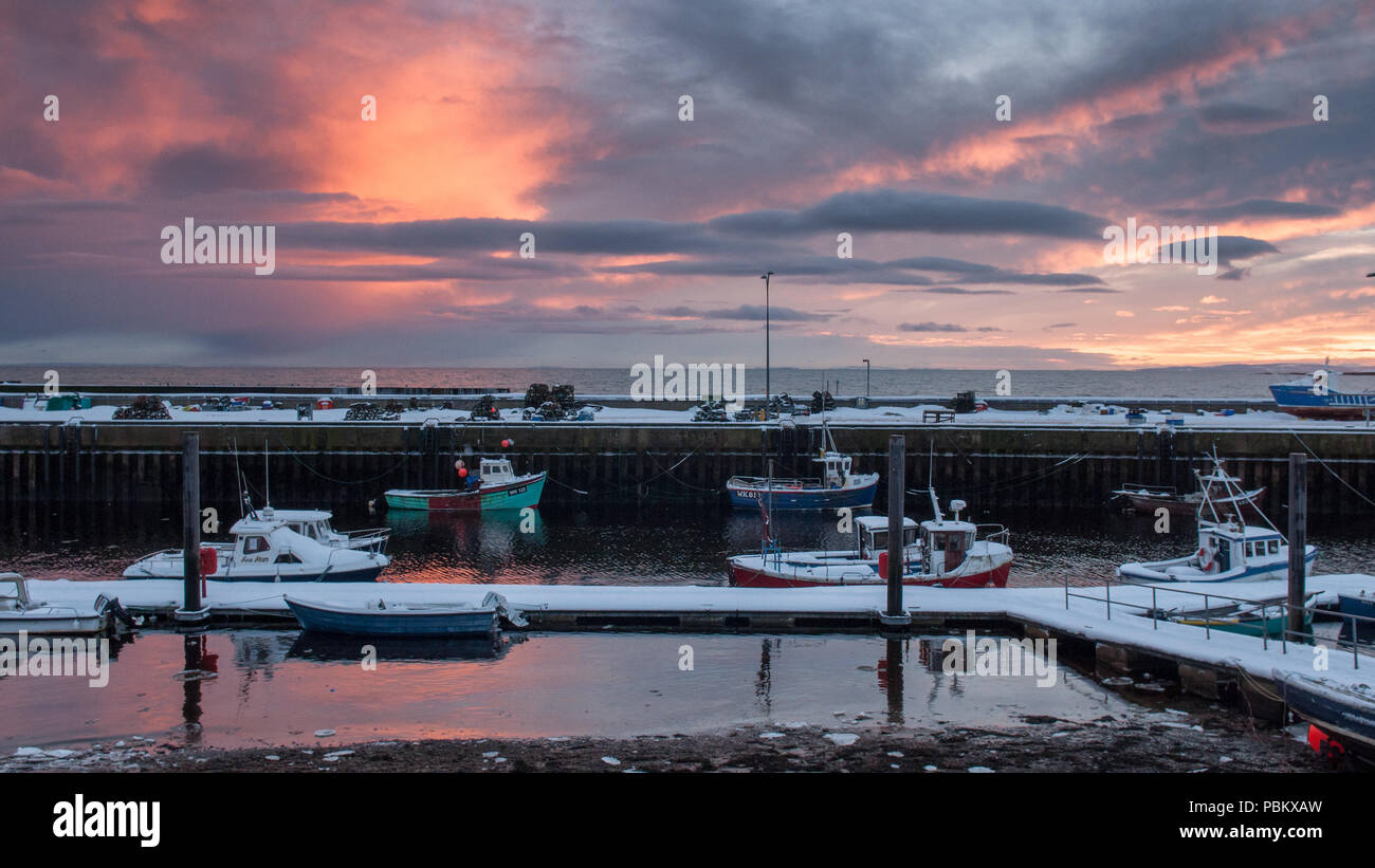 Helmsdale, Scotland, UK - December 3, 2010: Boats are moored in the harbour at Helmsdale on the Moray Firth coast of the Highlands of Scotland at suns Stock Photo