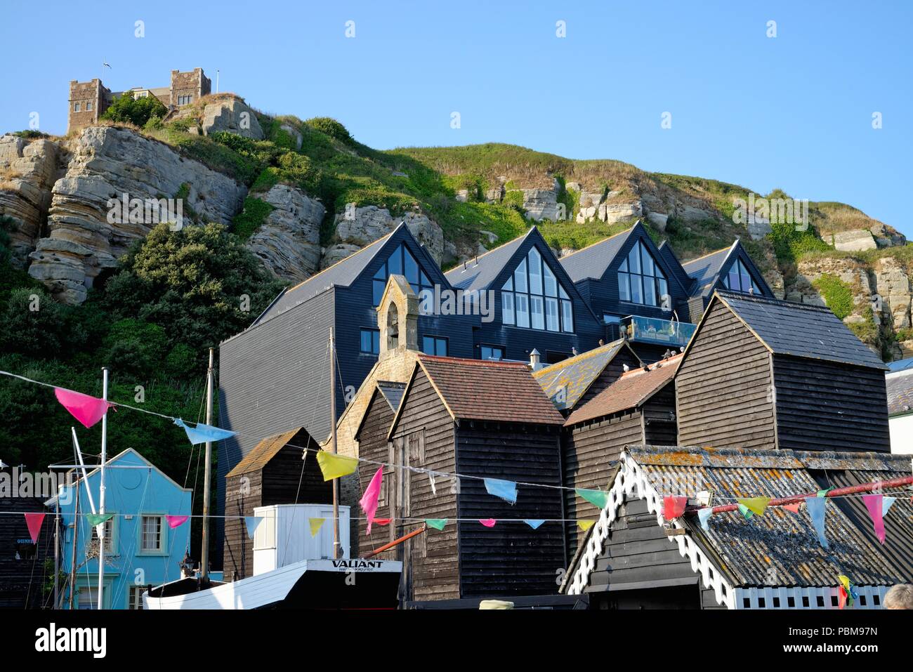 Modern apartments and historic net sheds in the East Cliff area of Hastings East Sussex England UK Stock Photo