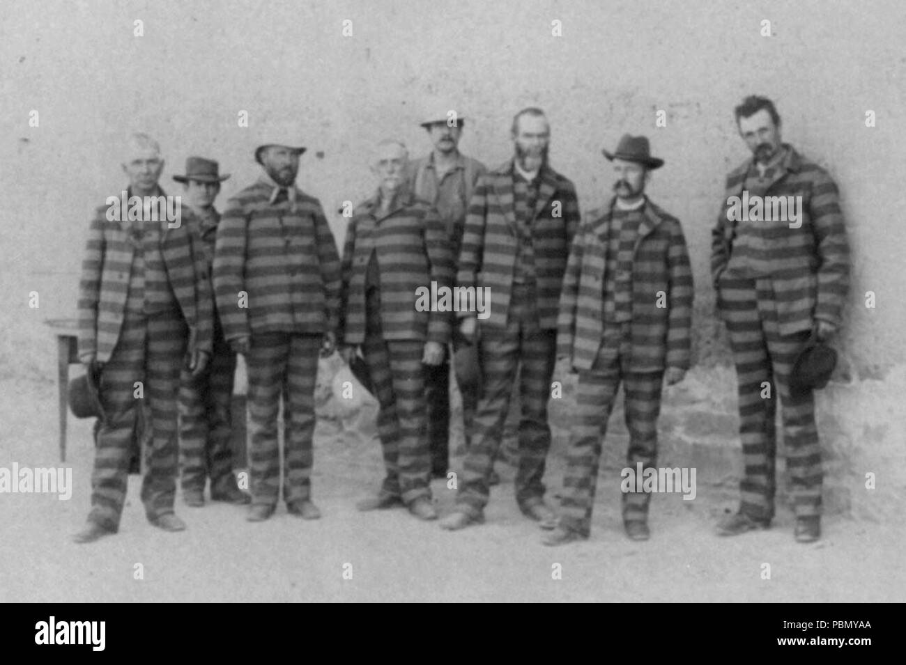 . English: Group of polygamists in the Utah Penitentiary, 8 men standing in prison stripes. circa 1885 930 LOC Utah Prisoners c1885 Stock Photo