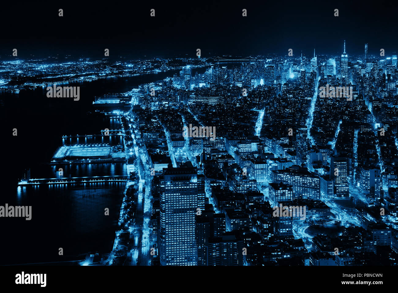 Rooftop night view of New York City midtown and Hudson River with urban ...