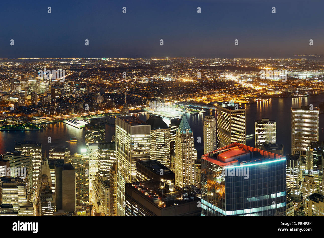 Rooftop night view of New York City downtown with urban skyscrapers ...