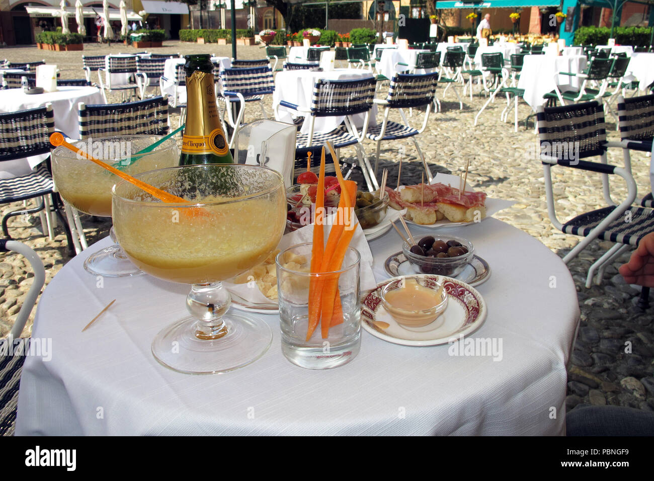 An extraordinary Bellini cocktail on a table in a café by the Piazzetta in Portofino, Italy. Stock Photo