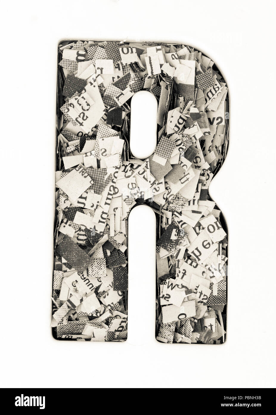 Capital letter made from cut up old newspaper Macro photography Stock ...