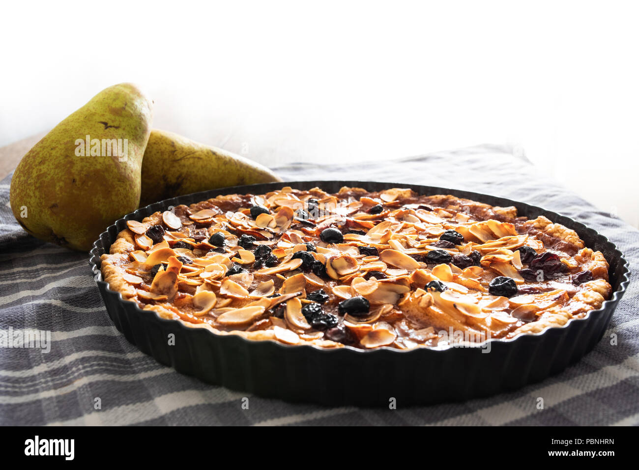 pear tart with raisins and sliced almonds Stock Photo