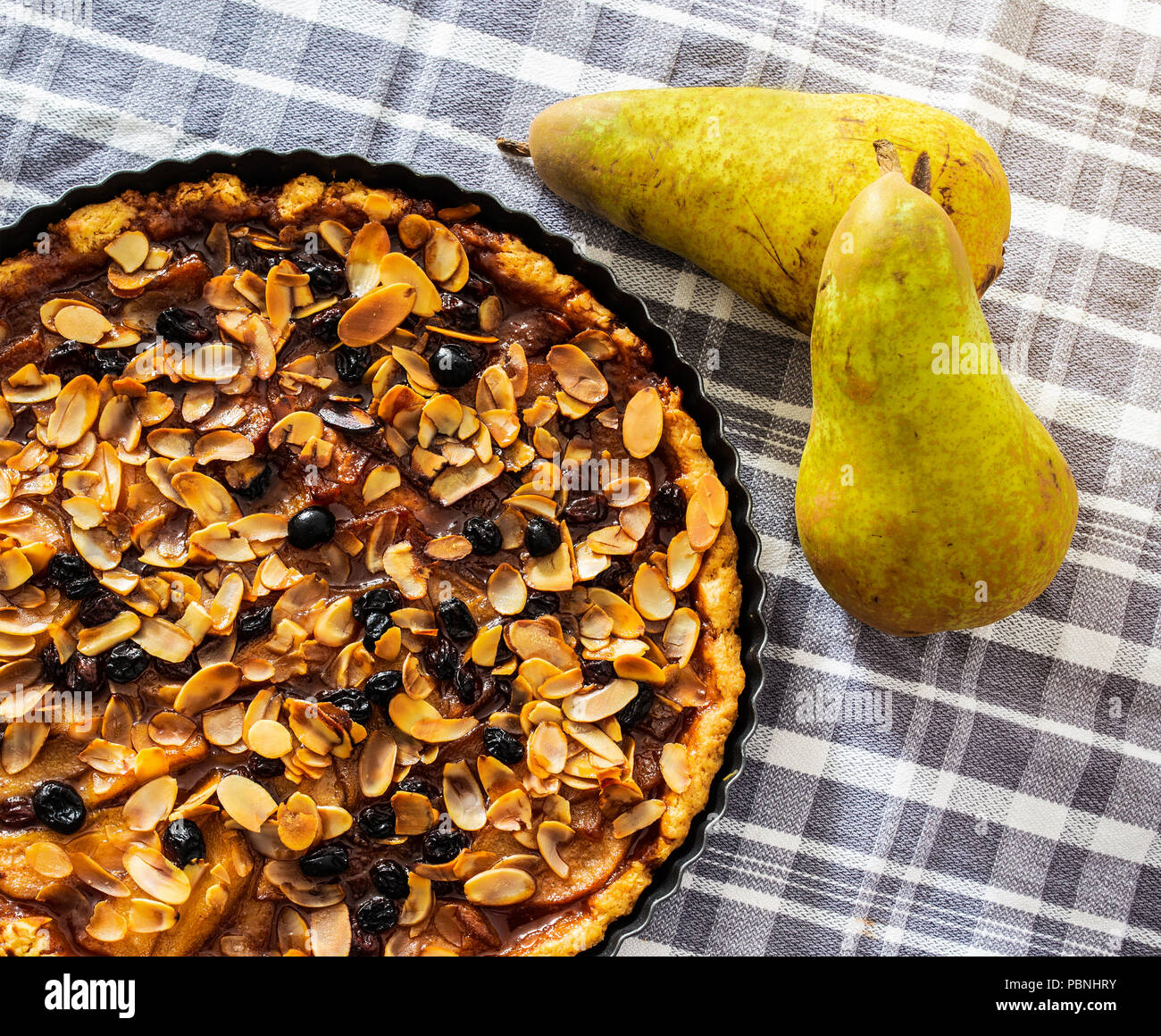 pear tart with raisins and sliced almonds Stock Photo