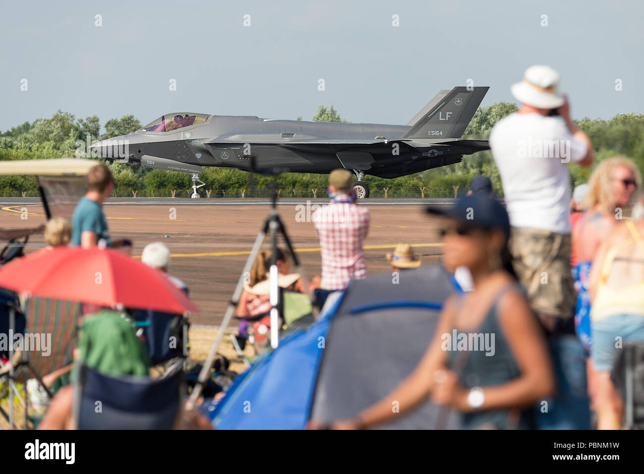 A Lockheed Martin F-35 Lightning II taxiing on the runway at RIAT Fairford 2018, UK, with spectators looking on. Stock Photo