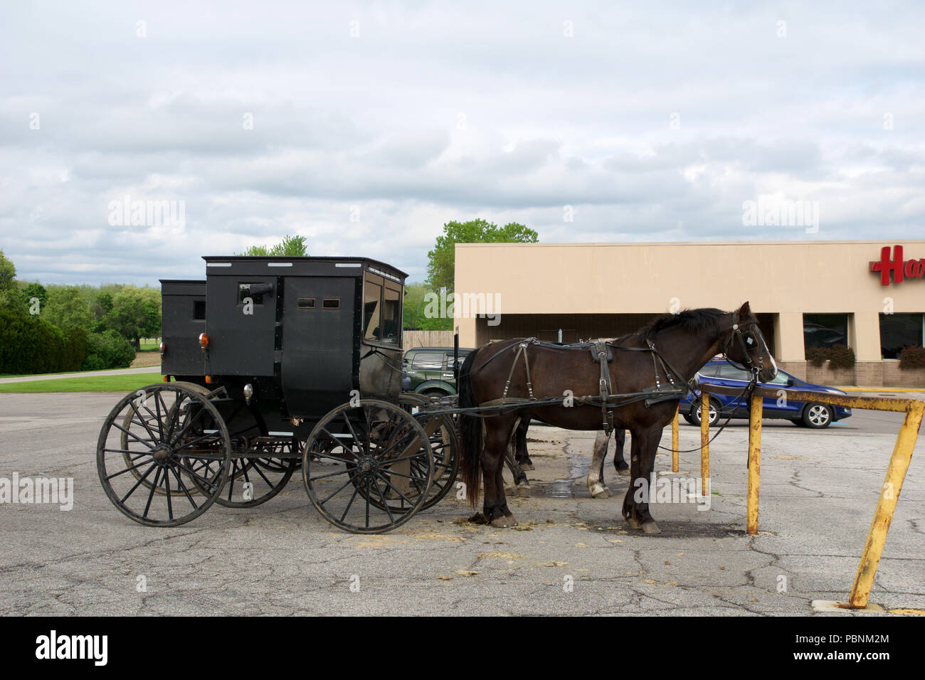 MIDDLEBURY, INDIANA, UNITED STATES - MAY 22nd, 2018: View of amish carriage along the city, known for simple living with touch of nature contacy, plain dress, and reluctance to adopt conveniences of modern technology Stock Photo