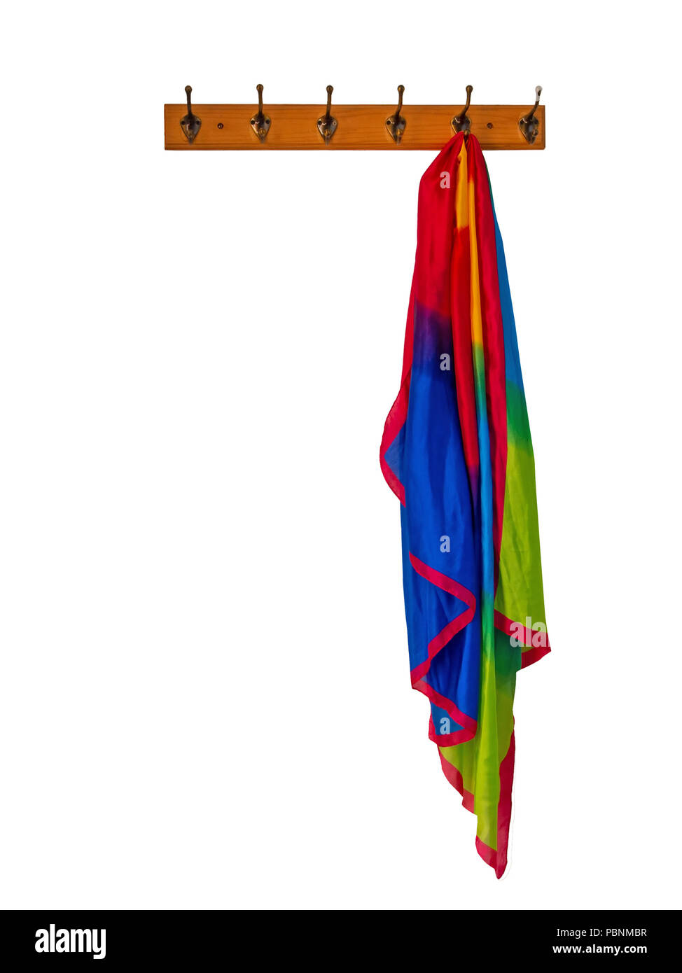 Rainbow silky scarf hanging on coat rack, isolated on white. Stock Photo
