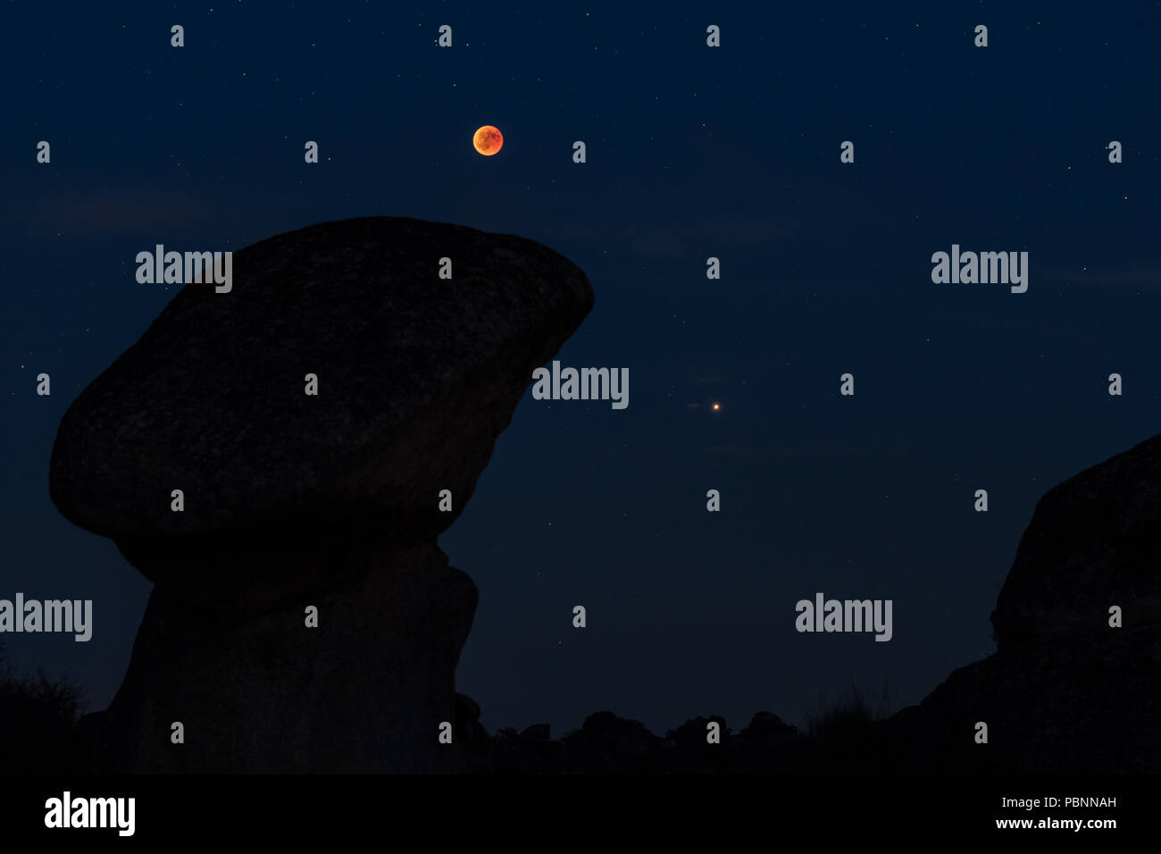 Lunar eclipse of July 27, 2018. Blood moon and planet Mars. Natural Area of the Barruecos. Estremadura. Spain. Stock Photo