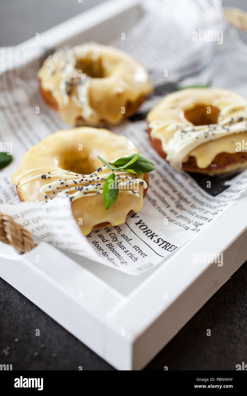 Lemon donuts with white chocolate and poppy seeds Stock Photo
