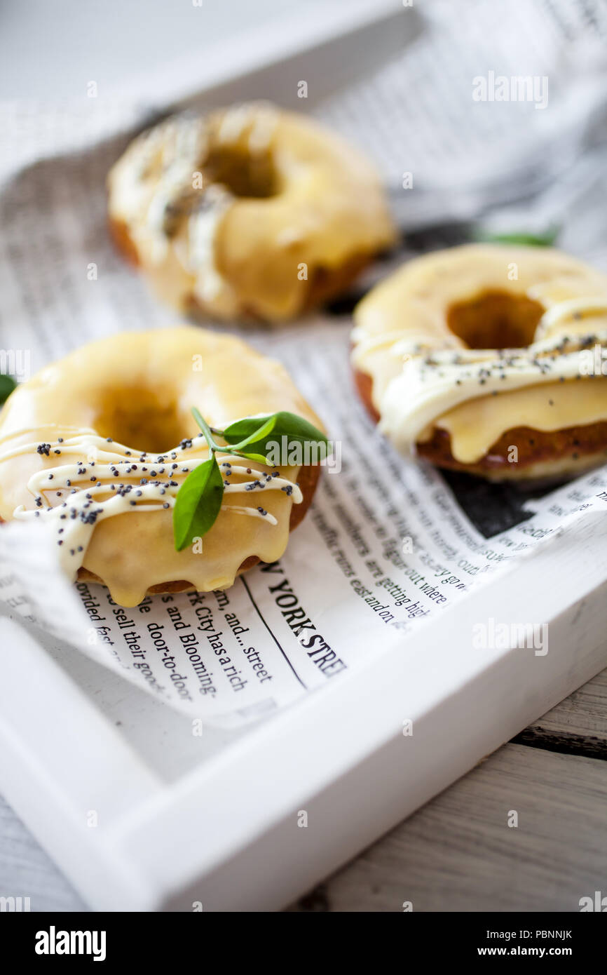 Lemon donuts with white chocolate and poppy seeds Stock Photo