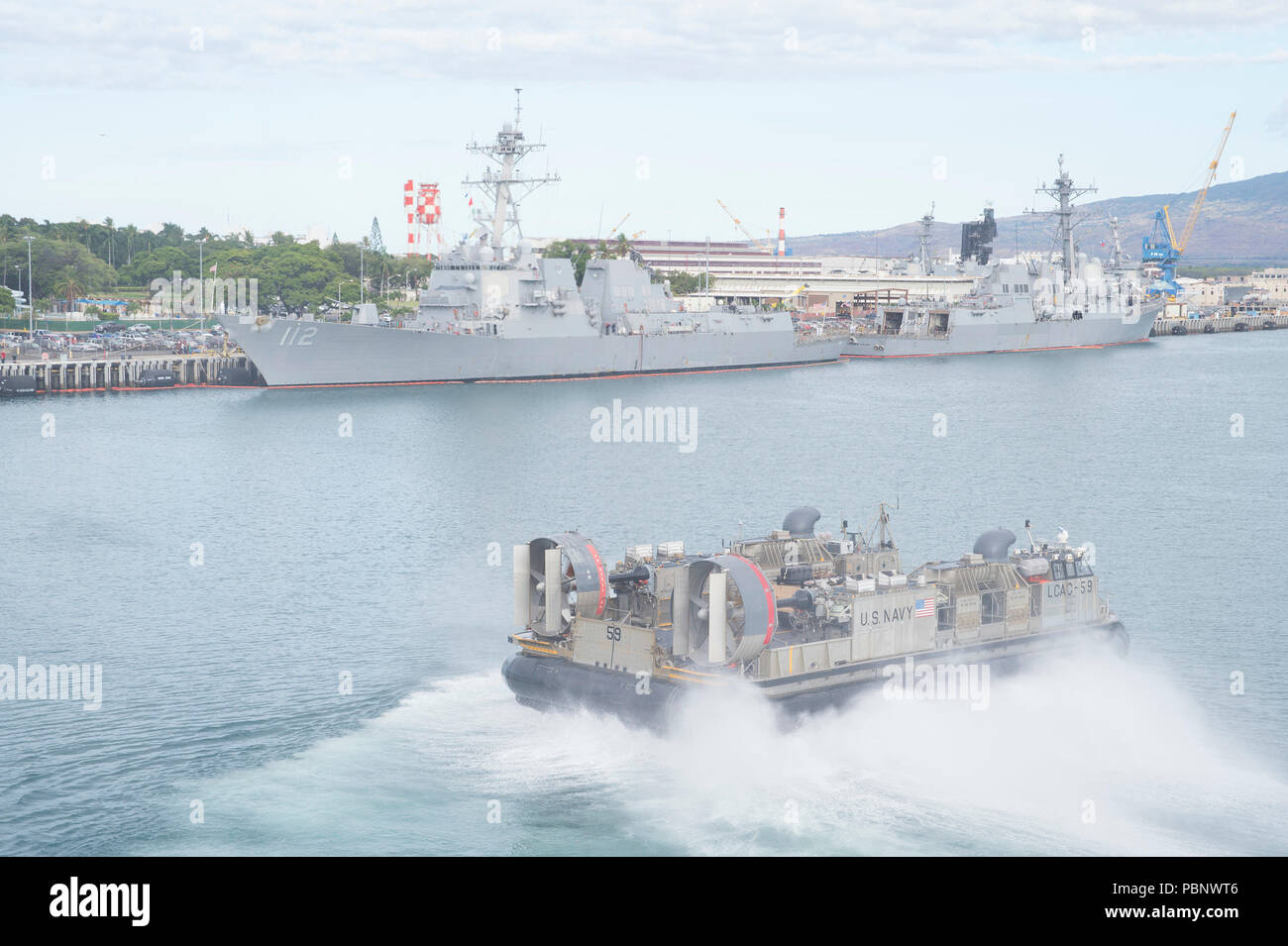 180726-N-RD713-1037 PEARL HARBOR, Hawaii (July 26, 2018) Landing craft air cushion (LCAC) 59, assigned to Assault Craft Unit (ACU) 5, departs the well deck of the amphibious assault ship USS Bonhomme Richard (LHD 6). Bonhomme Richard is currently underway in the U.S. 3rd Fleet area of operations. (U.S. Navy photo by Mass Communication Specialist 3rd Class Zachary DiPadova) Stock Photo