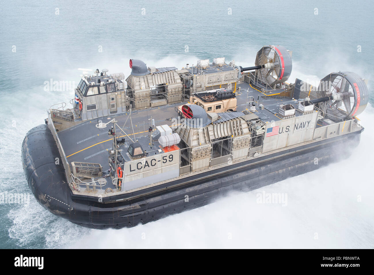 180726-N-RD713-1029 PEARL HARBOR, Hawaii (July 26, 2018) Landing craft air cushion (LCAC) 59, assigned to Assault Craft Unit (ACU) 5, departs the well deck of the amphibious assault ship USS Bonhomme Richard (LHD 6). Bonhomme Richard is currently underway in the U.S. 3rd Fleet area of operations. (U.S. Navy photo by Mass Communication Specialist 3rd Class Zachary DiPadova) Stock Photo