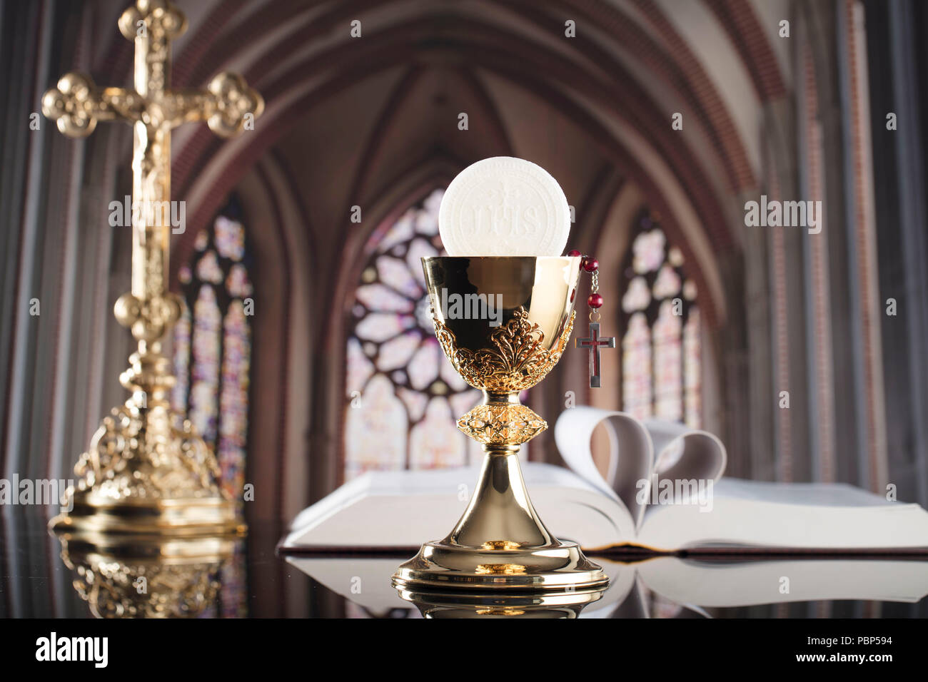 Roman Catholic Church theme. The Cross, Holy Bible, rosary and golden