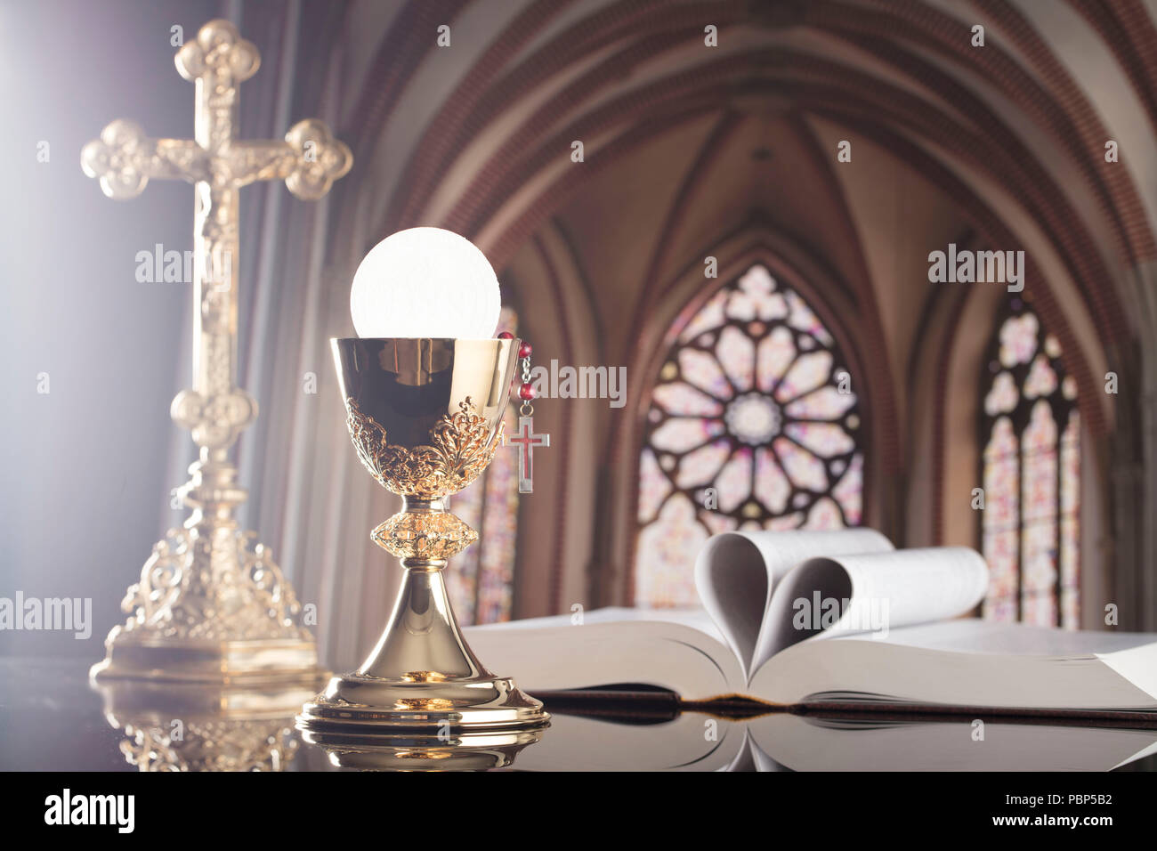 Roman Catholic Church theme. The Cross, Holy Bible, rosary and golden