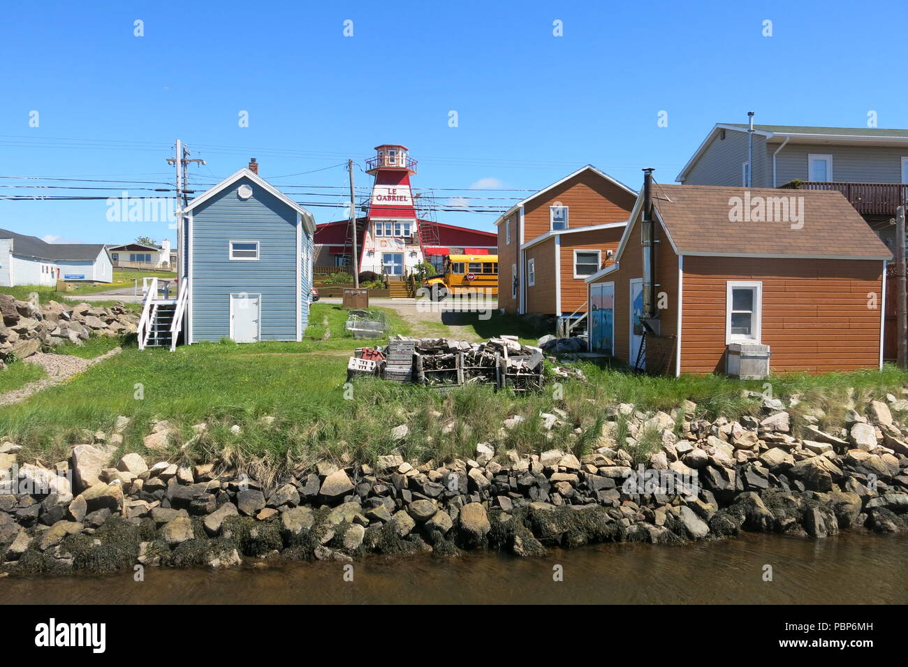 A view of the weatherboard cottages and red & white lighthouse in the