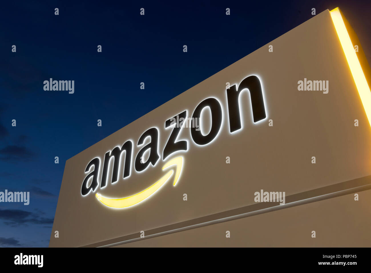 Illuminated signage at the Amazon fulfillment centre located in Warrington, UK. Stock Photo