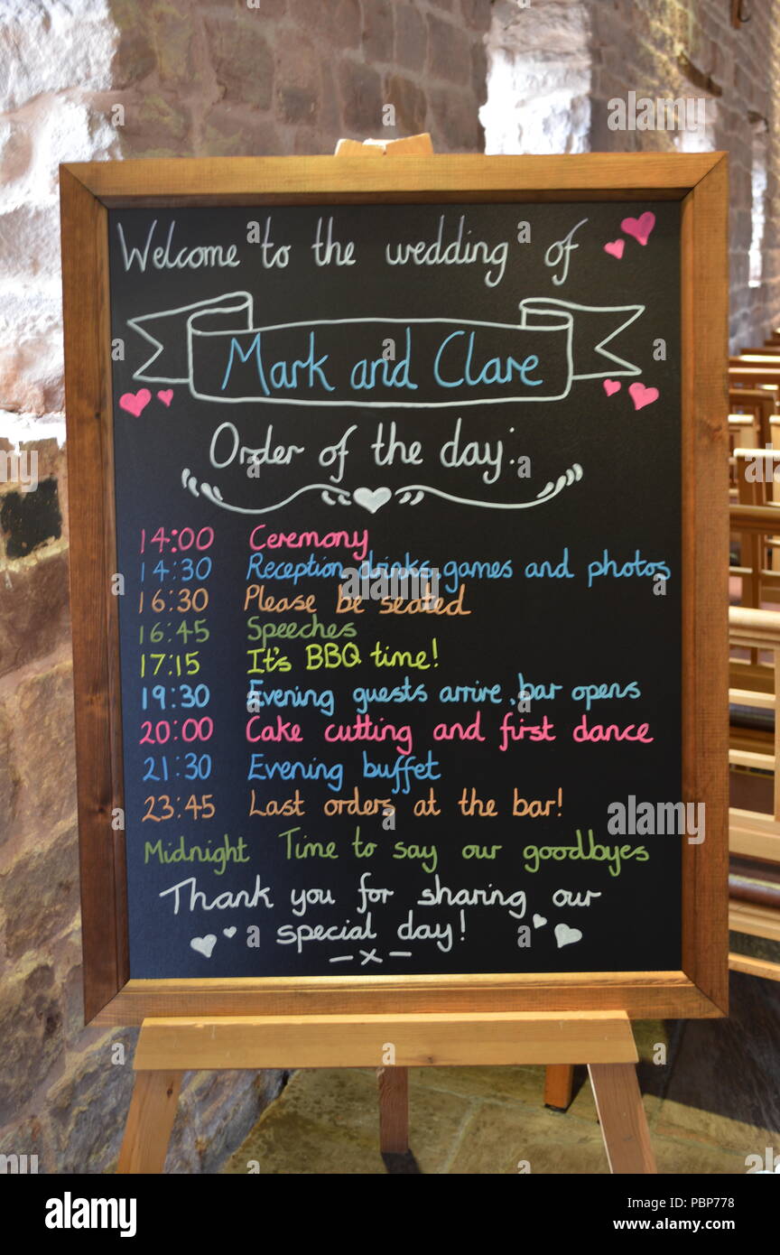 A Board Showing The Order Of The Day For A Wedding Reception In