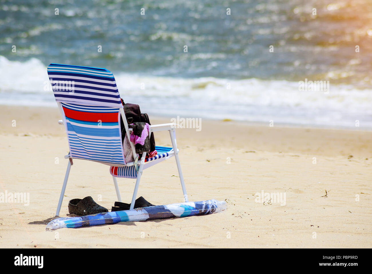 Beach chair on sand and summer hat beach overlooking the sea family ...