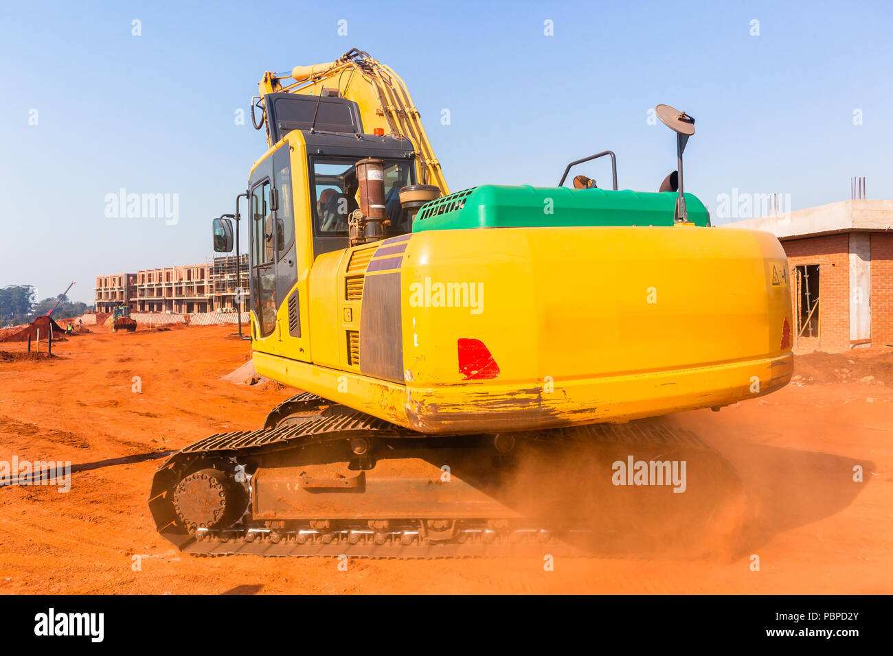 Construction apartments site of new building in progress with earthwork industrial excavator machines. Stock Photo