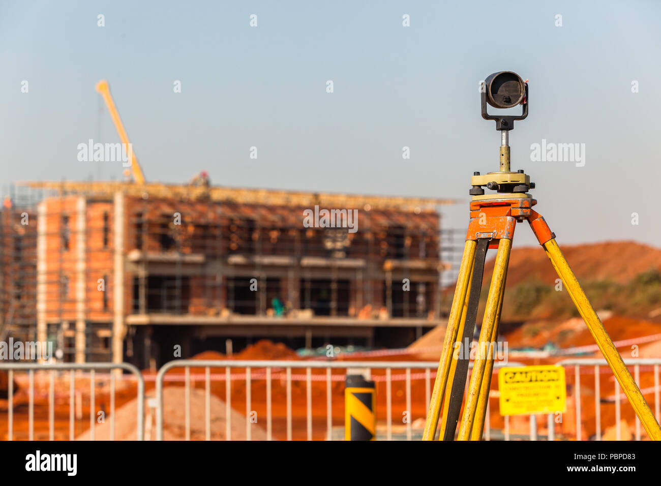 Construction building site landscape with land surveying tripod and