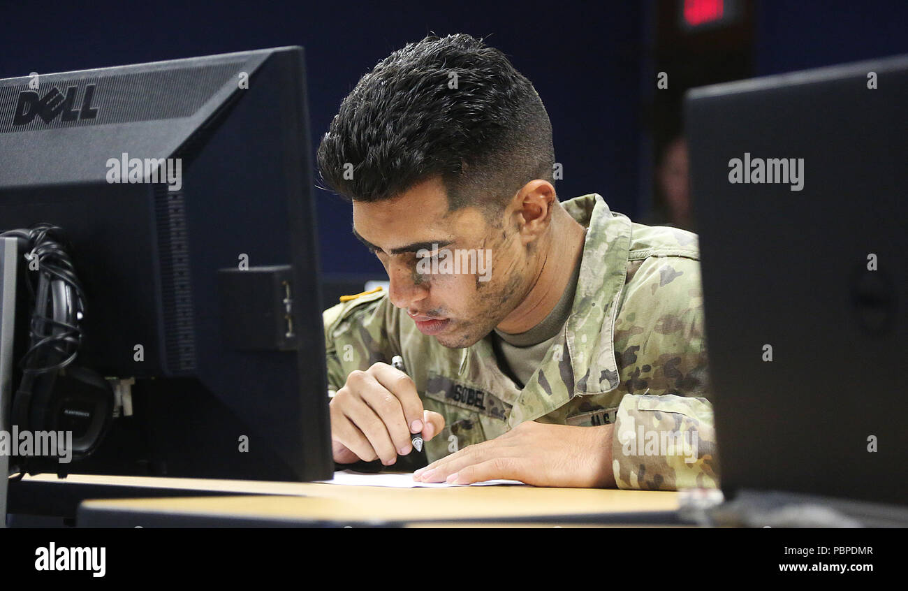 Spc. Nicholas Sobel from the U.S. Army Center for Initial Military Training, takes the written exam portion of the TRADOC Best Warrior Competition, Fort Gordon, Georgia, July 19, 2018. The Best Warrior Competition recognizes TRADOC NCOs and Soldiers who demonstrate commitment to the Army Values, embody the Warrior Ethos, and represent the force of the future by testing them with physical fitness assessments, written exams, urban warfare simulations, and other warrior tasks and battle drills. (U.S. Army photo by Pfc   Caeli Morris) Stock Photo