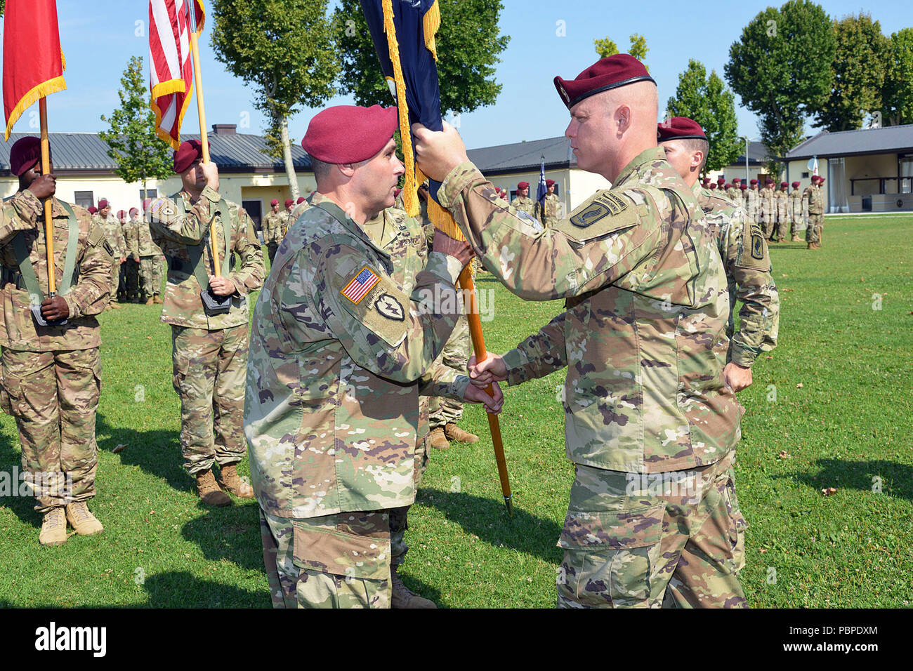 U.S. Army Command Sgt. Maj. Michael L. Palm, incoming Command Sgt. Maj. for the 1st Battalion, 503rd Infantry Regiment, 173rd Airborne Brigade (left), receives the colors to Lt. Col. Robert M. Shaw, commander of 1st Battalion, 503rd Infantry Regiment, 173rd Airborne Brigade, during the change of responsibility ceremony at Caserma Ederle in Vicenza, Italy, July 19, 2018. The 173rd Airborne Brigade is the U.S. Army Contingency Response Force in Europe, capable of projecting ready forces anywhere in the U.S. European, Africa or Central Commands' areas of responsibility. (U.S. Army photo by Davide Stock Photo
